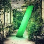a pergola with greenery and park bench, with illuminated green slash in centre