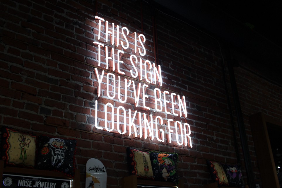 A neon sign reading This is the sign you've been looking for
